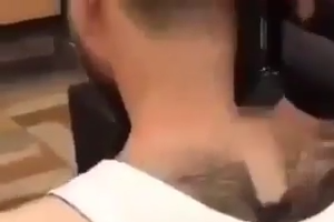 Barbar removing hair from man
