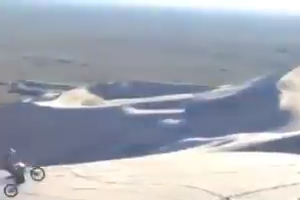 Man rides a motor bike on sand mountains - amazing